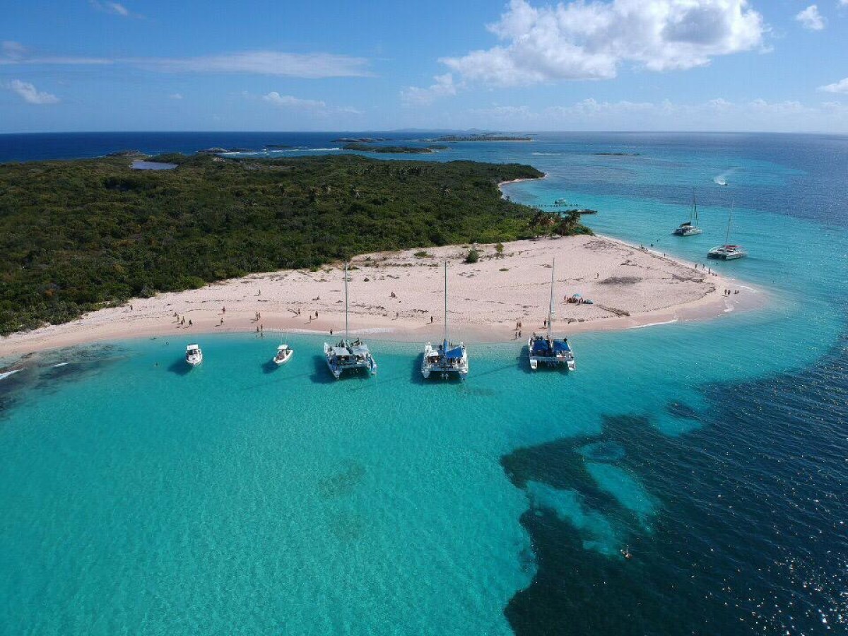 a group of people on a beach near a body of water